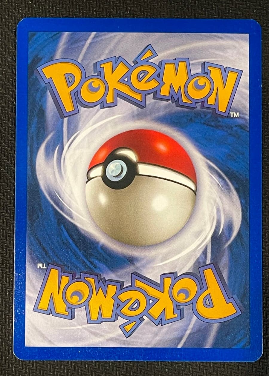 Reference photo: the back of the same card, framed and lit the same way as the front
